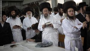 Ultra-Orthodox Jews wear white holiday cloths during noon prayers a few hours before the start of Yom Kippur, the Jewish holy day of Atonement, on September 17, 2010 at a synagogue in the central Israeli town of Bet Shemesh. Shops were to shut down and all motorized traffic come to a complete halt until the evening of 18 September to observe the Day of Atonement --a period of fasting, reflection and prayers on the holy day in the Jewish calendar. AFP PHOTO/MENAHEM KAHANA (Photo credit should read MENAHEM KAHANA/AFP/Getty Images)