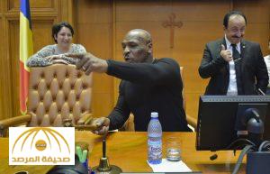 Former boxer Mike Tyson plays with the gavel used by the President of the Romanian Chamber of Deputies while visiting the giant palace built by late Romanian dictator Nicolae Ceausescu, which houses the Romanian Parliament, Wednesday, Oct. 5, 2016. Tyson arrived in Romania to promote an energy drink. (Mihai Poziumschi, Agerpres via AP)