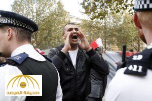 FILE - In this Wednesday, Oct. 26, 2016, file photo, police control protestors during a demonstration against the visit of the King of Bahrain, Hamad bin Isa Al Khalifa to Britain's Prime Minister Theresa May in Downing Street in London. A pro-democracy activist says his wife was beaten and arrested in Bahrain after he jumped on a car carrying the island’s king during his recent visit to London. (AP Photo/Kirsty Wigglesworth, File)