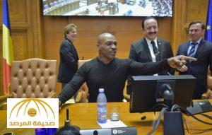 Former boxer Mike Tyson plays with the gavel used by the President of the Romanian Chamber of Deputies while visiting the giant palace built by late Romanian dictator Nicolae Ceausescu, which houses the Romanian Parliament, Wednesday, Oct. 5, 2016. Tyson arrived in Romania to promote an energy drink. (Mihai Poziumschi, Agerpres via AP)