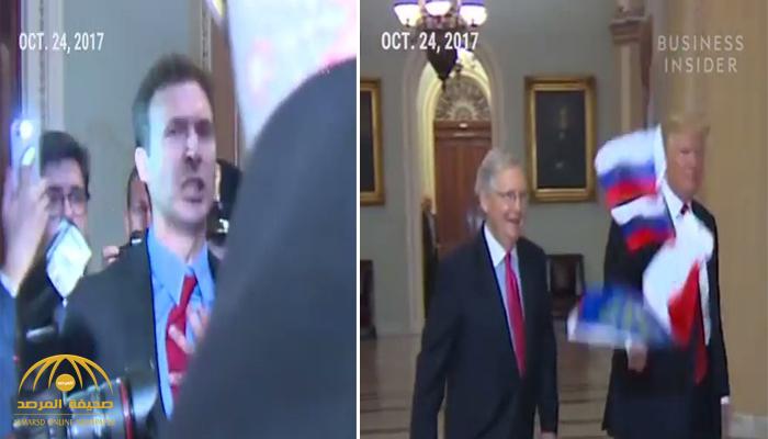 بالفيديو .. شخص يرمي ترامب بأعلام روسية داخل الكونغرس ويهتف "خائن"