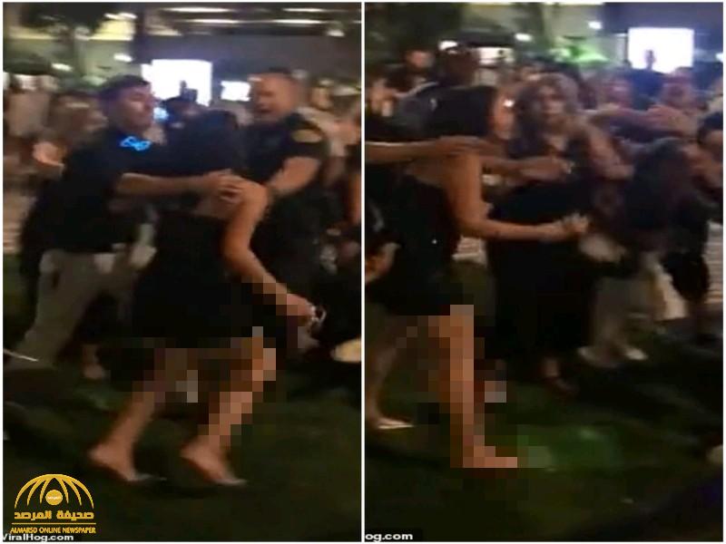 شاهد : ردة فعل فتاة مخمورة تجاه شرطي حاول القبض على صديقها أمام ملهى ليلي  في ميامي الأمريكية!