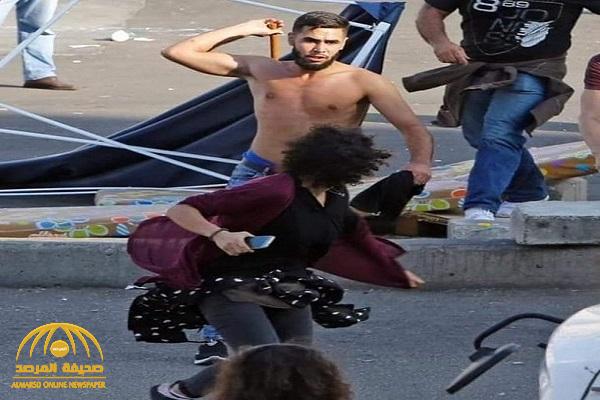 شاهد : عنصر من حزب الله اللبناني "عارياً" يعتدي على متظاهرة في بيروت