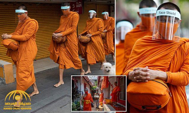 شاهد : البوذيون يرتدون "دروعًا واقية" من كورونا.. وتايلاند تجرم "النكات" بشأن الفيروس وتكشف عن العقوبة