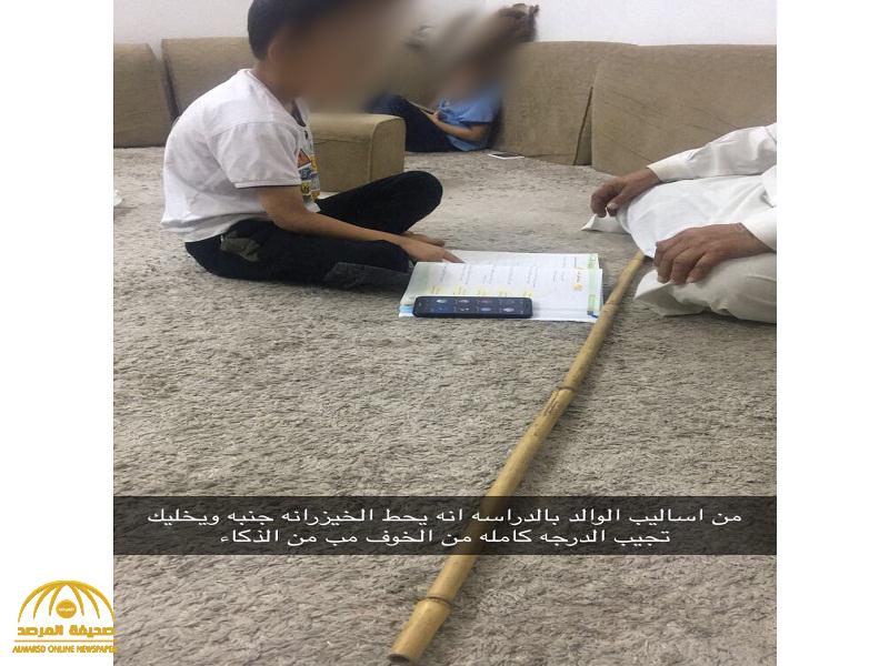 شاهد.. صورة  أب سعودي يُعلم ابنه وبجواره عصا خشبيه تثير الجدل على تويتر